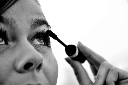 Young girl doing eye makeup