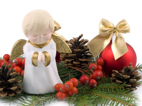 Little ceramic angel and red christmas glass ball on white background