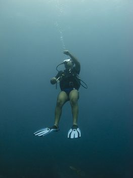 Scuba diver heading for the surface and doing bubble