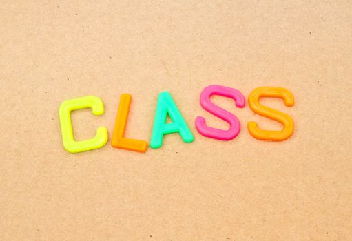 Class in colorful toy letters on paper background