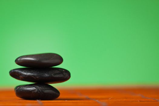 Stack of balancing black stones: background with lots of copy-space