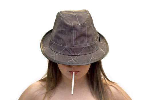 Young woman in a hat with a cigarette in his mouth. Close-up, studio shot, white background.