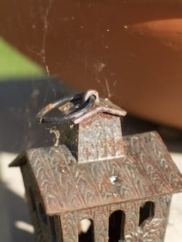 Rusty birdhouse with cobwebs, forgotten and very old.