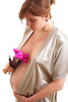 pregnancy woman in the dressing gown with flower