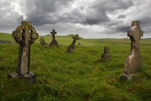 Ancient Celtic gravesite with unmarked gravestones from the 1600's in the middle of a meadow in rural Scotland.
