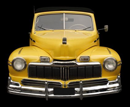 The grill, hood and headlamps of an antique classic car.
