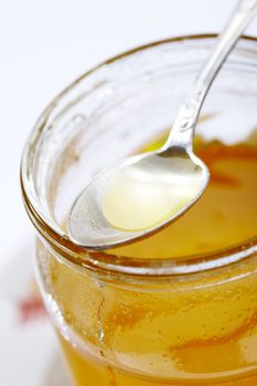 glass of honey with spoon