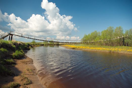 Suspension bridge over the river.Old Style Suspension Bridge -- crossing a mountain river
