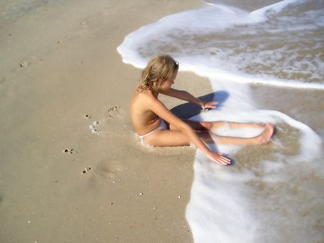 two girl friends sea on the shore await wave. 