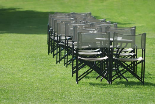 Empty chairs in a green garden