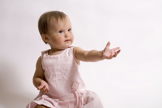 eight month baby. little girl in the pink dress