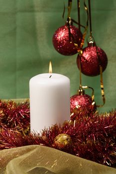 christmas stil life decoration with candle and red xmas decorated ball