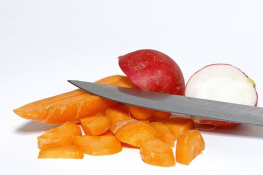 Sliced carrot and cutted garden radish stillife with table-knife