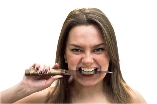 Young woman with green eyes holding a knife in his teeth. Studio shot on white background.