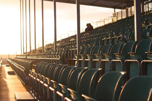 Silverstone grandstand empty except for two people at dusk