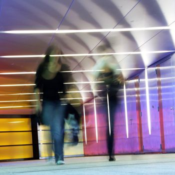 multi colored underground tunnel with people in morion