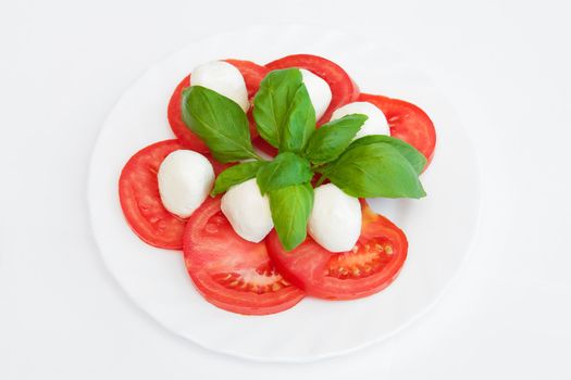 Tomatoes with mozzarella on the white