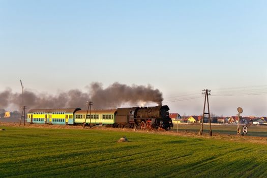Vintage steam train passing through countryside
