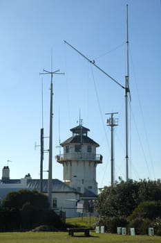 old rusty lighthouse, several mast, annex building