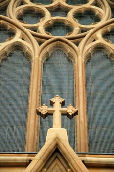 church detail, brown cross and blue windows