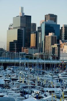 boat show in Darling Harbour, Sydney. Pyrmont bridge and skyscrapers in background. Dusk.