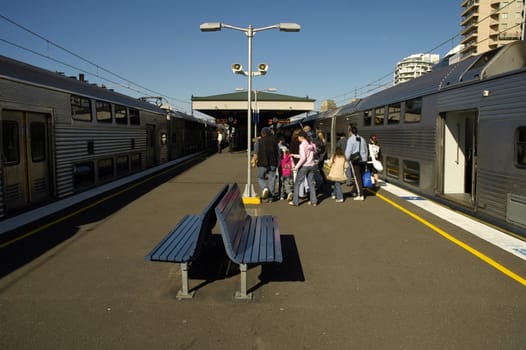 people getting out of a train in outdoor railway station, location: Sydney - Kirribilli