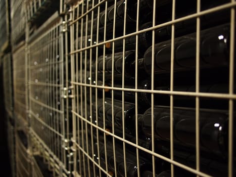 Containers full with newly produced wine bottles in a wine factory.  