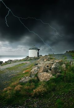 Lightning strike and strong wind blowing by the ocean in Land's End, UK