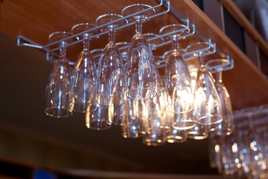 Hanging wine and champagne glasses in a bar
