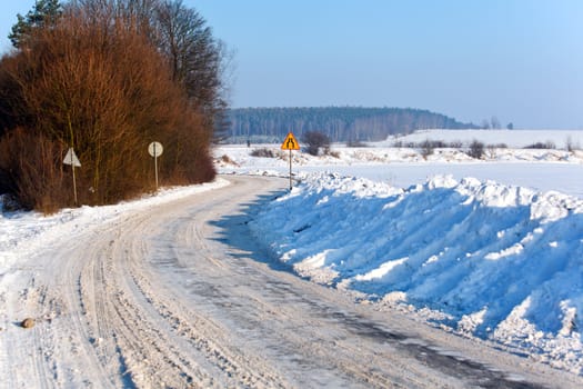 Snowy road through the countryside during wintertime

