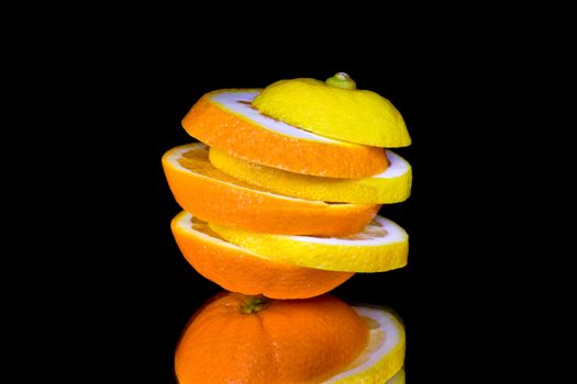 Orange and lemon slices composition isolated on black background
