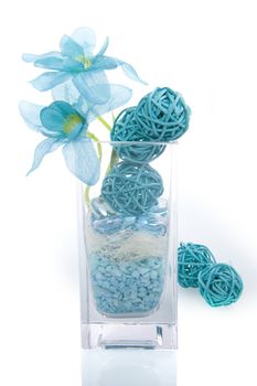 a vase with blue flowers and blue decoration