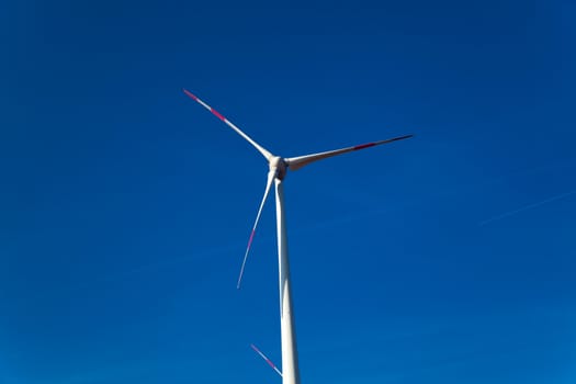 Wind turbine and against blue sky
