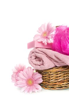 a towel, a sponge, soap and a flower in a basket