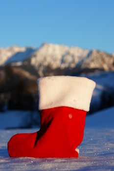 Santa Claus Christmas boot for gifts outside in a snowy landscape