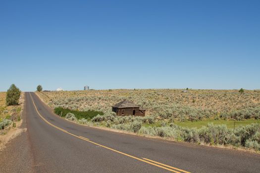 Desert Highway with Abandoned House in Central Oregon