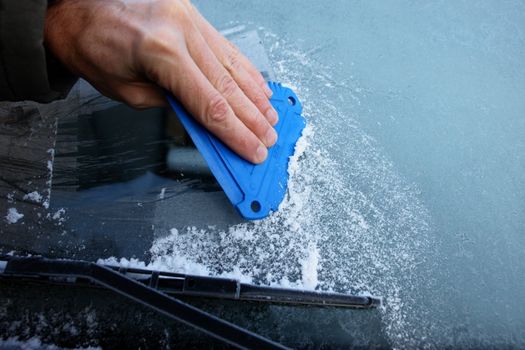 car windshield covered with ice and snow