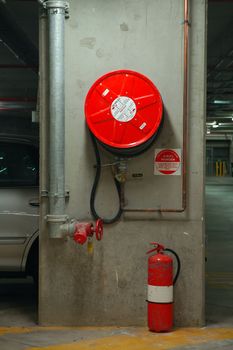 fire hose reel and extinguisher in an underground garage