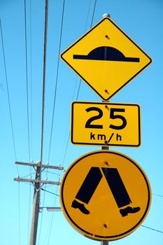 three yellow australian signs: retarder, speed limitation, pedestrian cross walk, 