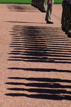 australian soldiers in attention, detail photo of their shadows, photo taken in Canberra