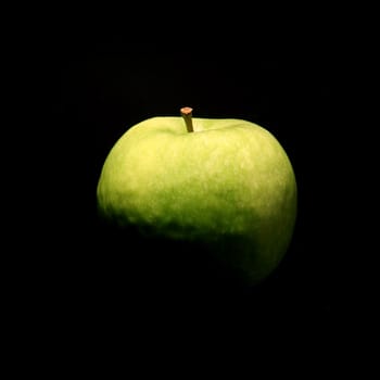 green fresh apple on black background, no light reflex