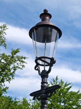 Classical decorated metal street lamp on a pole