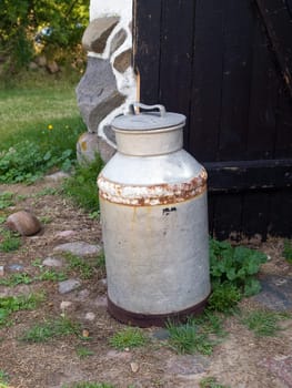 Milk organic traditional can jug in a dairy farm