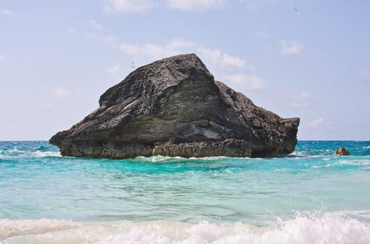 A large rock in the atlantic ocean in the coastal waters of Bermuda. Photo was taken at Horseshoe Bay in Bermuda.