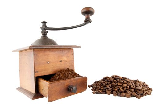 Rustic coffee grinder with coffee beans and ground coffee