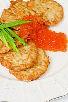 pancakes with red caviar and green onion closeup dish
