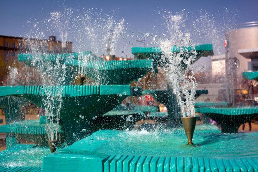 Splashes of fountain water in a sunny day 
