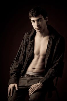 portrait of a young man with unbuttoned shirt