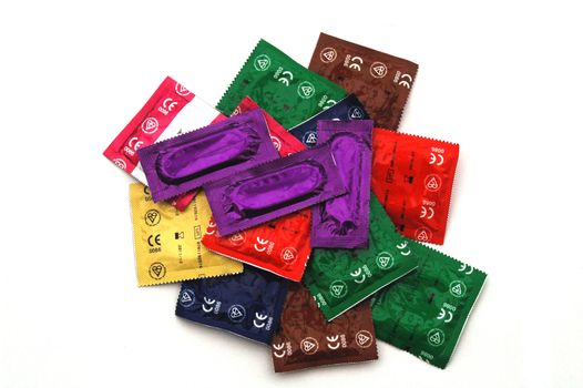 Brightly Coloured Condom Packs on white Background. These do not have makers Markings, just British Standard Kite Marks and European Standard Mark, so suitable for any use