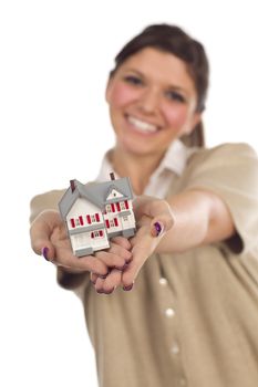Pretty Smiling Ethnic Female Holding Out Small House in Front Isolated on a White Background - Focus is on the House.